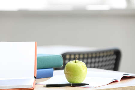Apple with books on table in classroomの写真素材