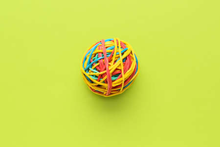 Colorful rubber band ball on green background