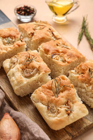 Wooden board with traditional Italian focaccia on table, closeupの写真素材