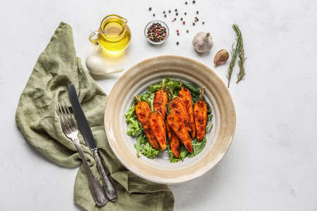 Composition with tasty baked carrots, spices and oil on light backgroundの写真素材