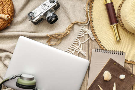 Accessories for traveling with laptop on wooden backgroundの写真素材