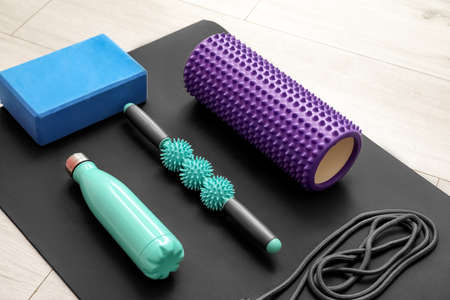 Sports equipment with bottle on wooden floor