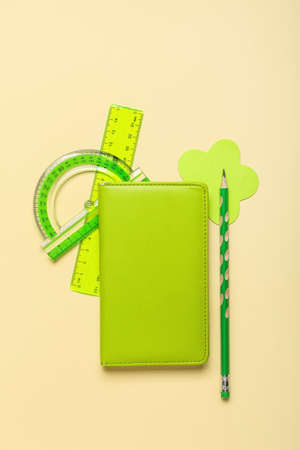 Green school stationery on beige backgroundの写真素材