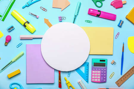 Blank paper sheet with school stationery on blue backgroundの写真素材