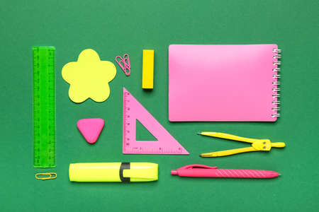 school stationery on green background