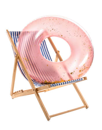 Striped deck chair with inflatable ring on white background