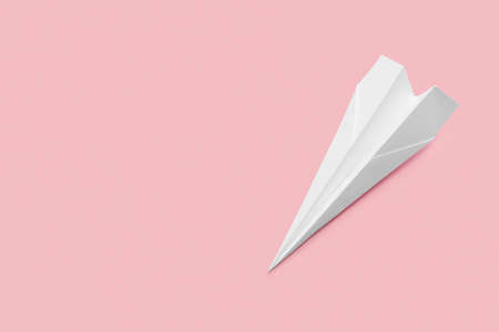 White paper plane on pink backgroundの写真素材