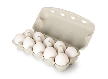 Cardboard holder with fresh eggs on white background