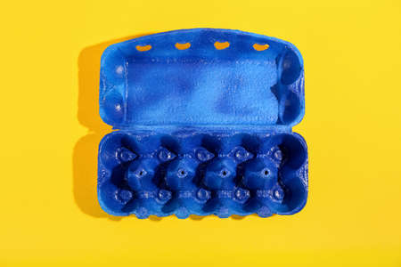Blue eggs holder on yellow background