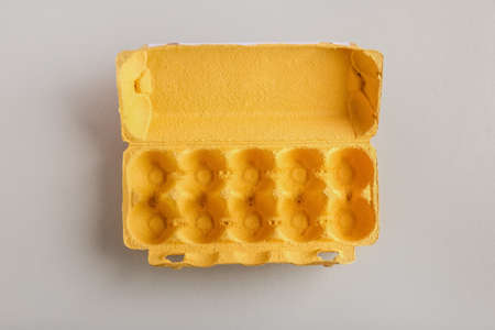 Empty cardboard holder for eggs on light background