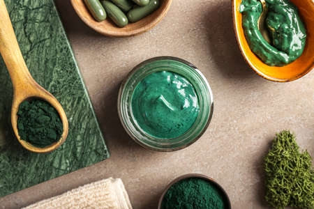 Jar of spirulina facial mask on tableの写真素材