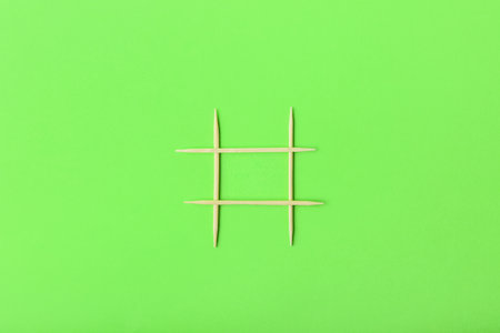 Grid made of toothpicks on green backgroundの写真素材