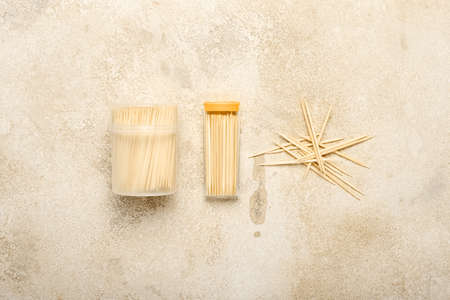Holders with toothpicks on light background