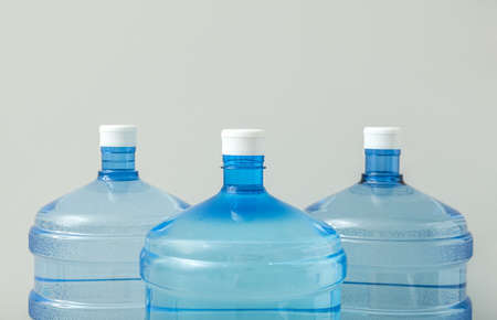 Bottles of clean water on light background