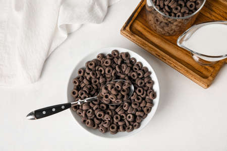 Bowl of black cereal rings on light backgroundの写真素材