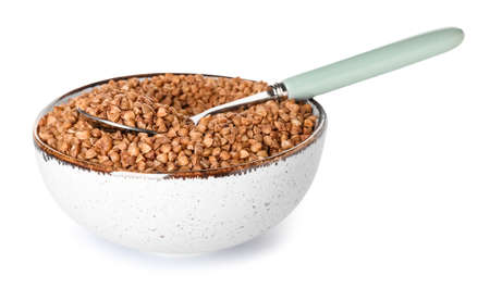 Bowl with buckwheat grains and spoon on white backgroundの写真素材
