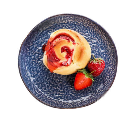 Plate with strawberry cinnamon roll on white backgroundの写真素材