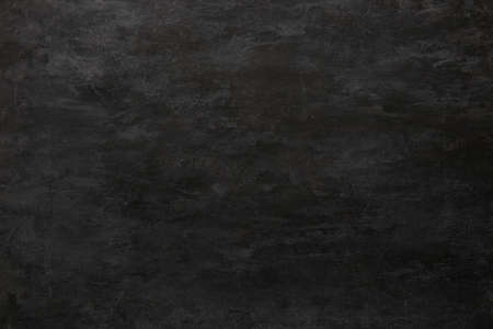 Black grunge wall as background, close up