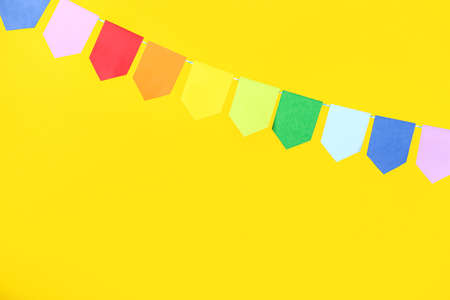 Colorful flags for Festa Junina on yellow background