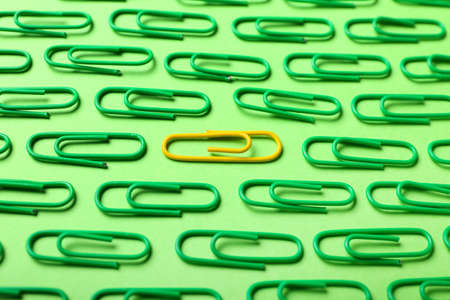 Yellow and green paper clips on color backgroundの写真素材