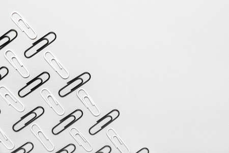 Black and white paper clips on light backgroundの写真素材