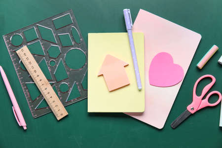 Stationery supplies on school chalkboard