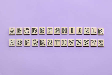 Different letters on lilac background. Alphabet conceptの写真素材