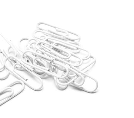 Many paper clips on white backgroundの写真素材