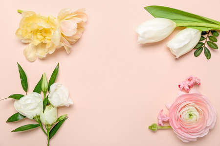 Frame made of different flowers on pink backgroundの写真素材