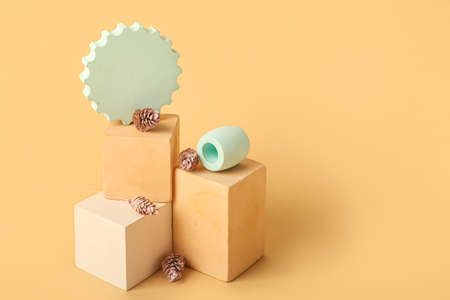 Composition with showcase pedestal and floral decor on color background