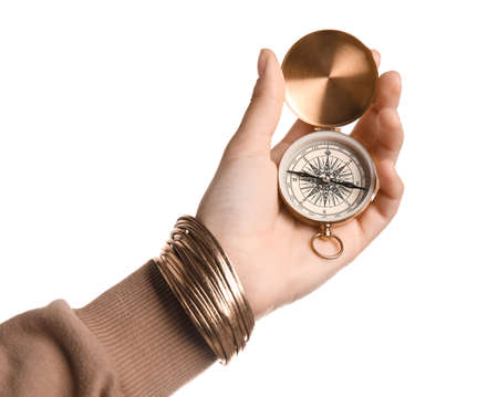 Woman with golden compass on white background