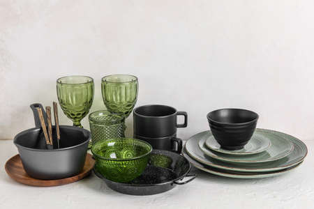 Set of stylish dark dinnerware on light background