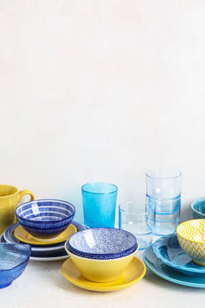 Set of color dinnerware on light backgroundの写真素材