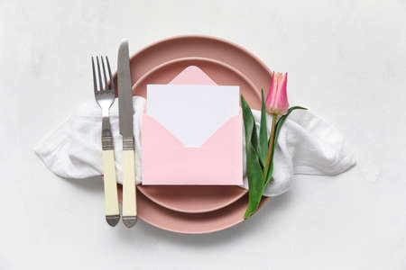 Simple table setting with tulip on white background