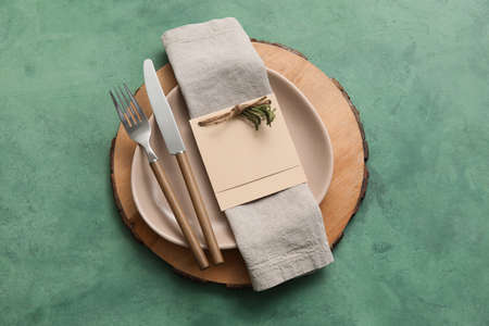 Simple table setting with floral decor on green background