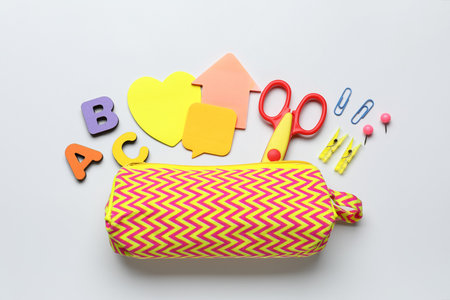 Pencil case and stationery on white background