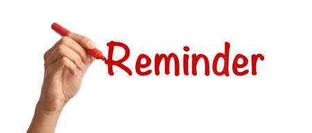 Man with marker writing word REMINDER on white background