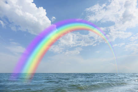 View of the sea and beautiful rainbow in the skyの写真素材