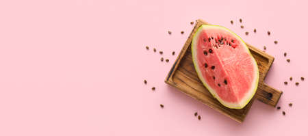 Cut sweet watermelon on pink background with space for textの写真素材
