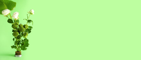 Beautiful ikebana on green background with space for textの写真素材
