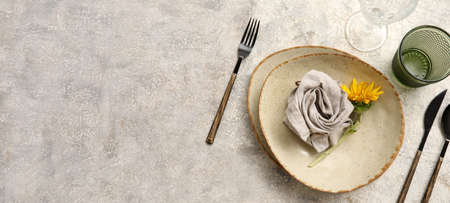 Beautiful table setting with fresh sunflower on grunge background with space for textの写真素材