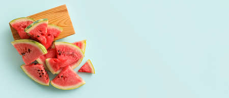 Cut sweet watermelon on light blue background with space for text, top viewの写真素材
