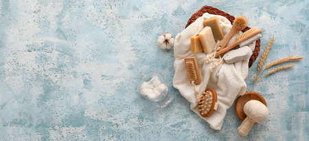 Set of bath supplies on light blue background with space for text
