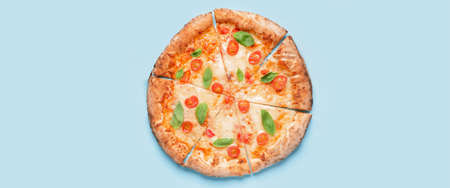 Delicious cut pizza Margarita on light blue background, top viewの写真素材