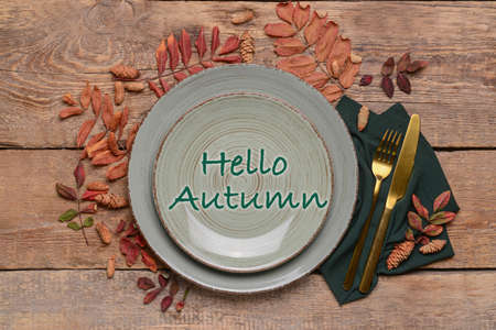 Table setting with autumn leaves on wooden backgroundの写真素材