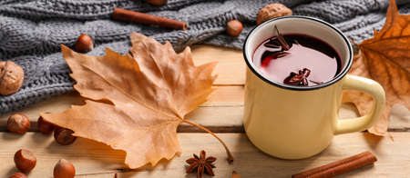 Mug of delicious mulled wine on wooden tableの写真素材