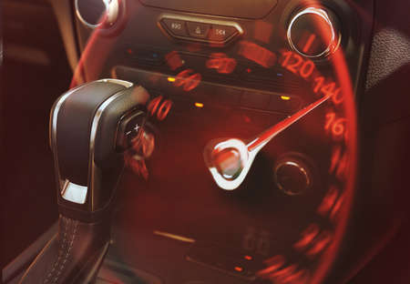 Double exposure of speedometer and transmission gearbox of modern racing car, closeup