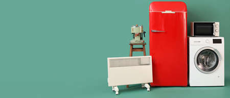 Stylish household appliances on green background with space for textの写真素材