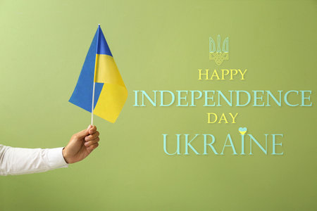 Hand with flag of Ukraine on green background. Poster for Ukrainian Independence Dayの写真素材