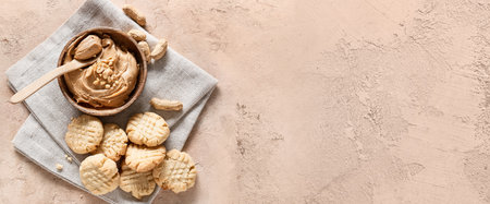 Tasty peanut cookies and butter in bowl on grunge background with space for textの写真素材